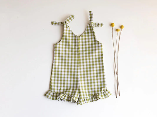 Green checkered romper with ruffles on a white background