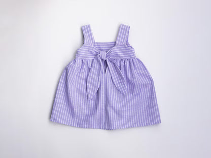 Purple striped dress with a bow on a light gray background
