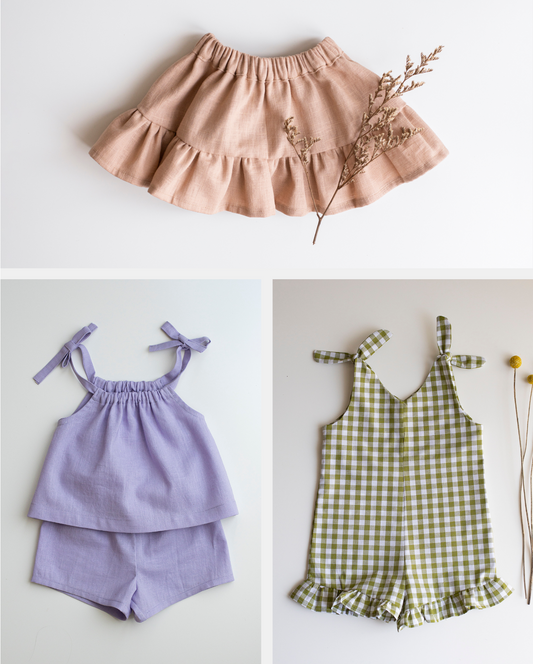 Three children's outfits including a pink skirt, purple top and shorts set, and green checkered romper on a white background.