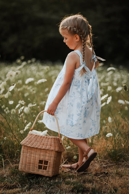 Easy beginner children’s sewing pattern for a classic dress with wide shoulder straps, empire waist, gathered skirt, and open back with bow tie detail.