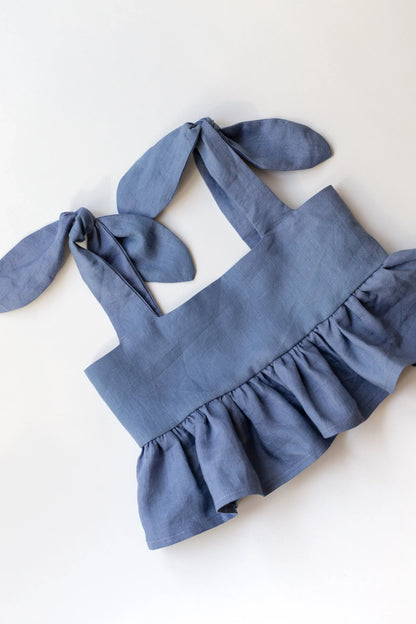 Blue children's top with bunny ears on a white background