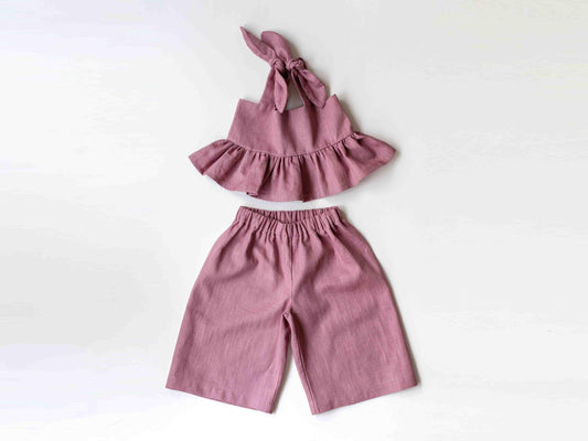 Pink children's outfit with top and pants on a white background