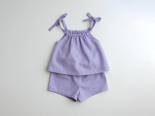 Lavender children's top and shorts set on a light gray background
