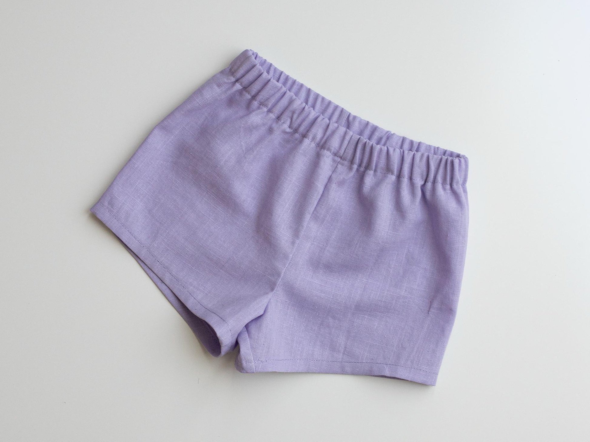 Purple shorts on a light gray background