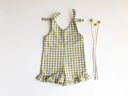 Green checkered romper with ruffles on a white background
